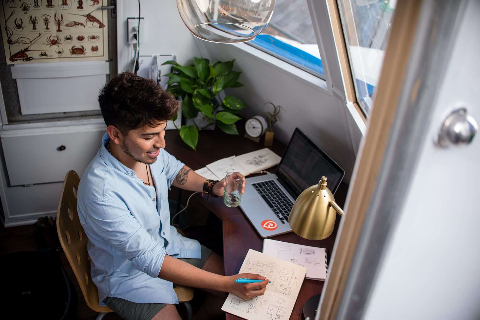 Young technology professional sitting at desk looking at artificial intelligence staffing and talent solutions