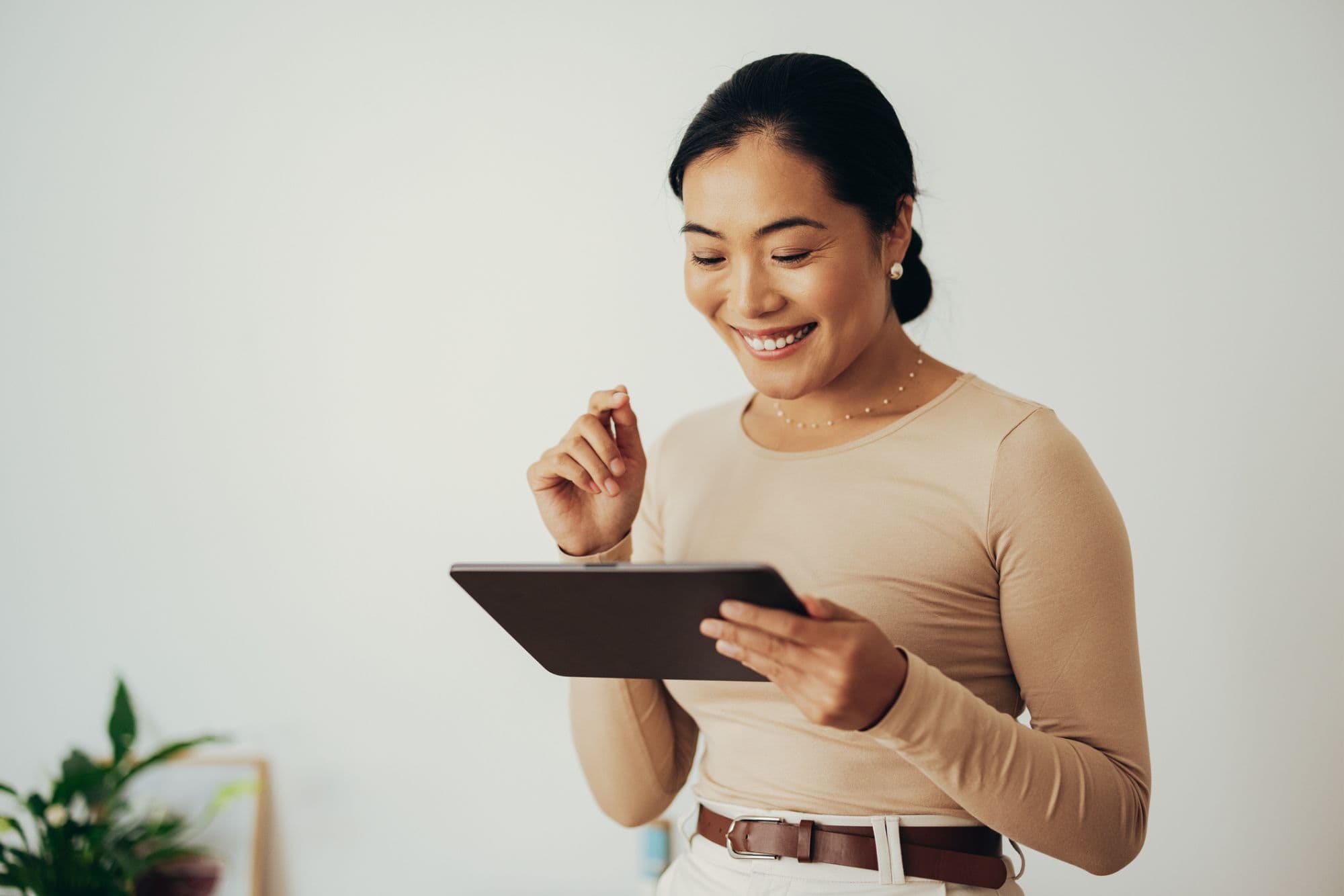 Copywriter woman holding tablet looking at content & writing staffing services