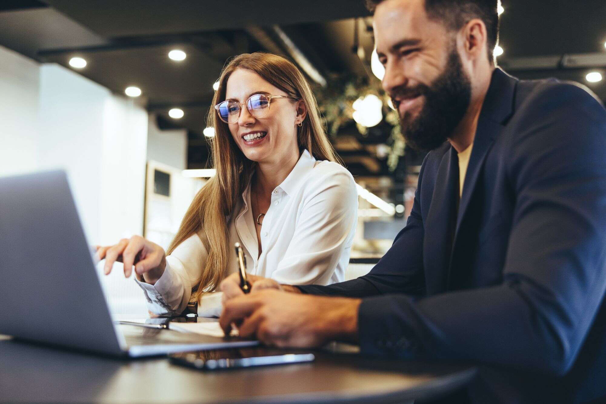Two content writers looking at laptop at freelance writing staffing services